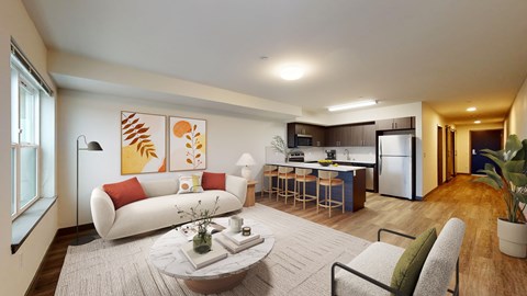 a living room with a couch and a table in front of a kitchen